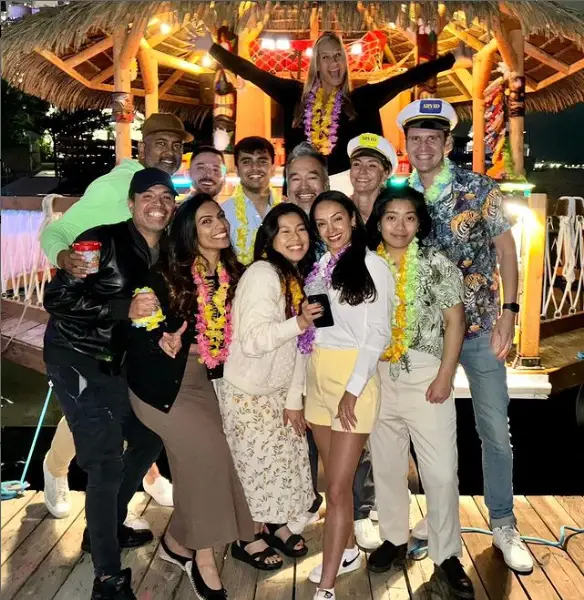 A big group celebrating on a tiki boat at night in Toronto